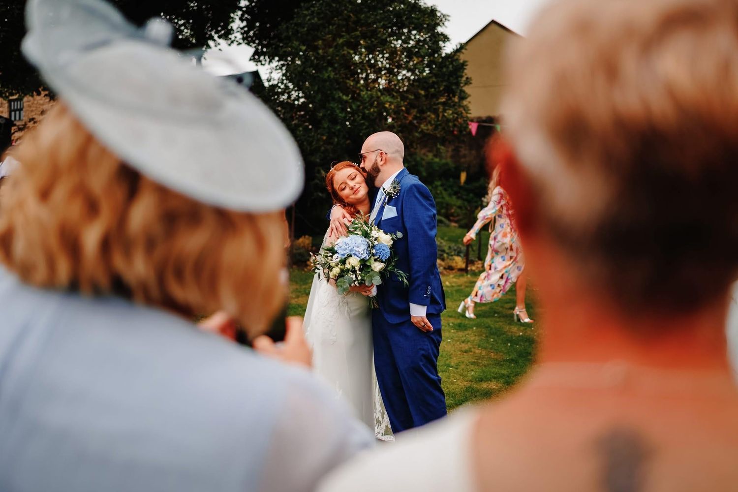Wedding celebration candid moments captured in an outdoor garden setting.