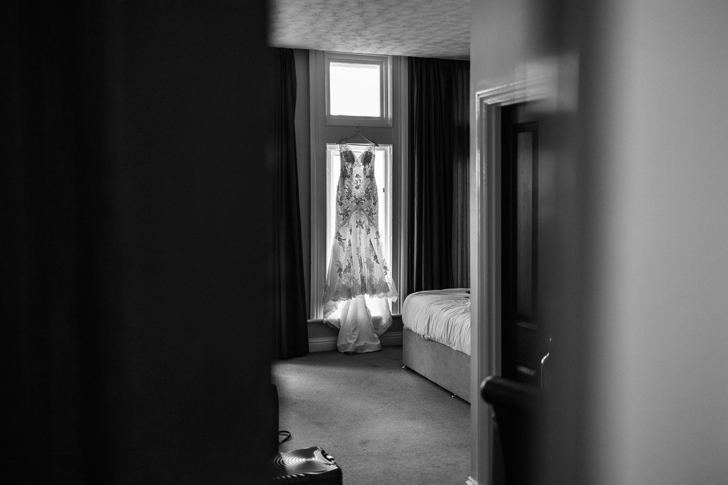 A haunting black and white series of photographs showing empty interior spaces with dramatic lighting and shadows.
