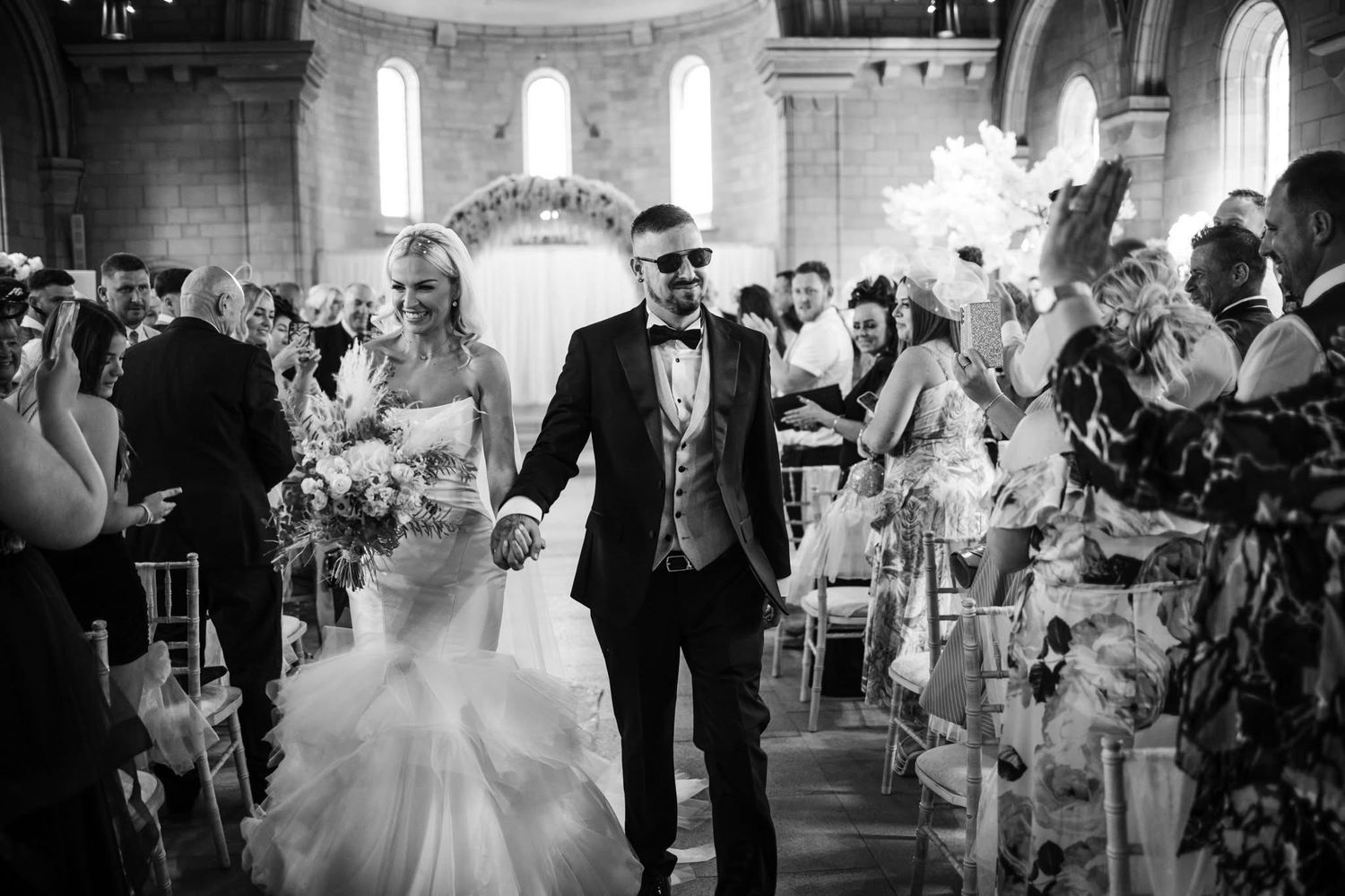 A black and white photo montage of a wedding celebration showing dancing and festivities inside an elegant venue.
