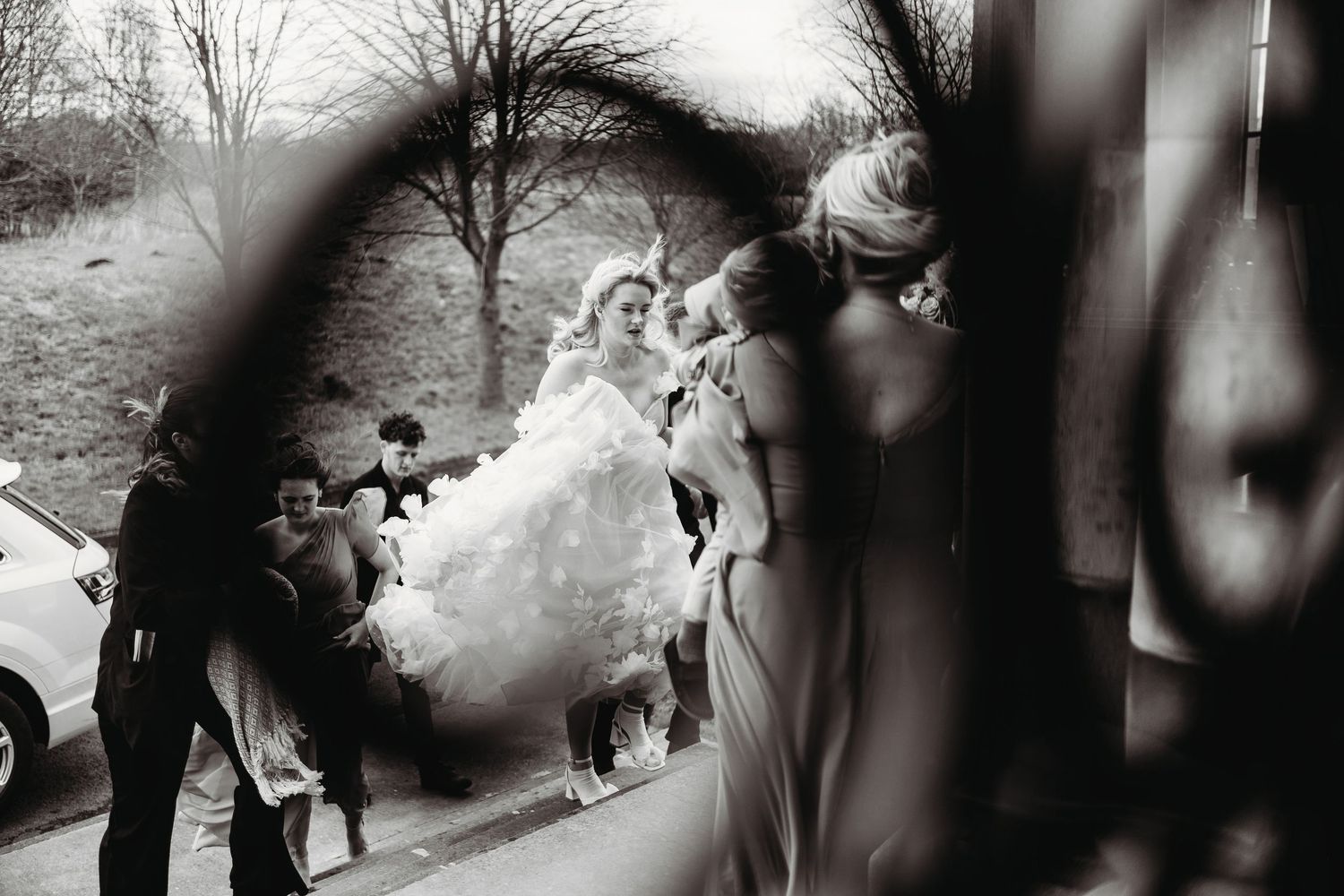 A black and white photo montage of a wedding ceremony and celebration showing romantic moments and dancing.