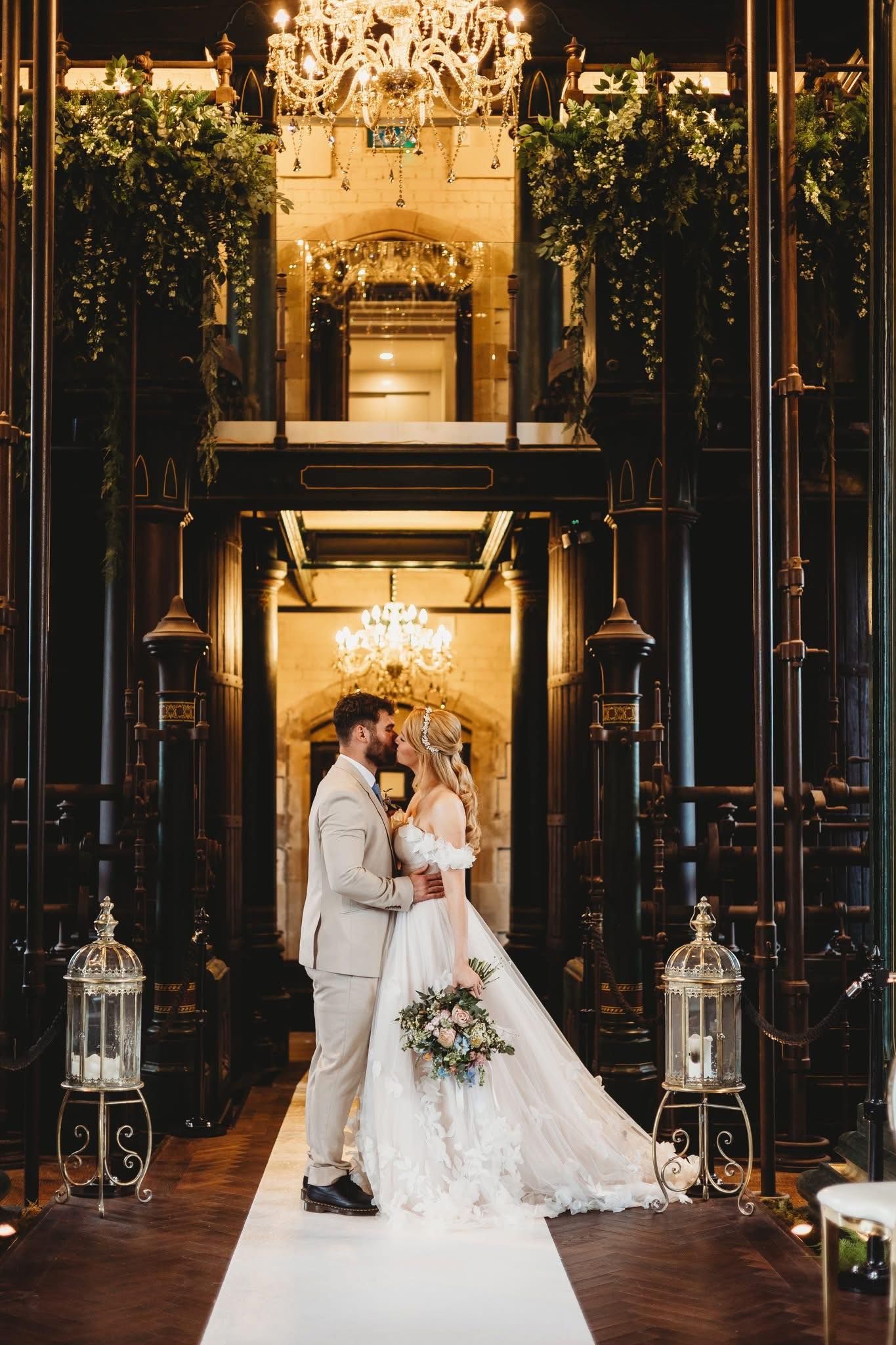 Elegant ballroom wedding venue with crystal chandeliers and dramatic lighting.