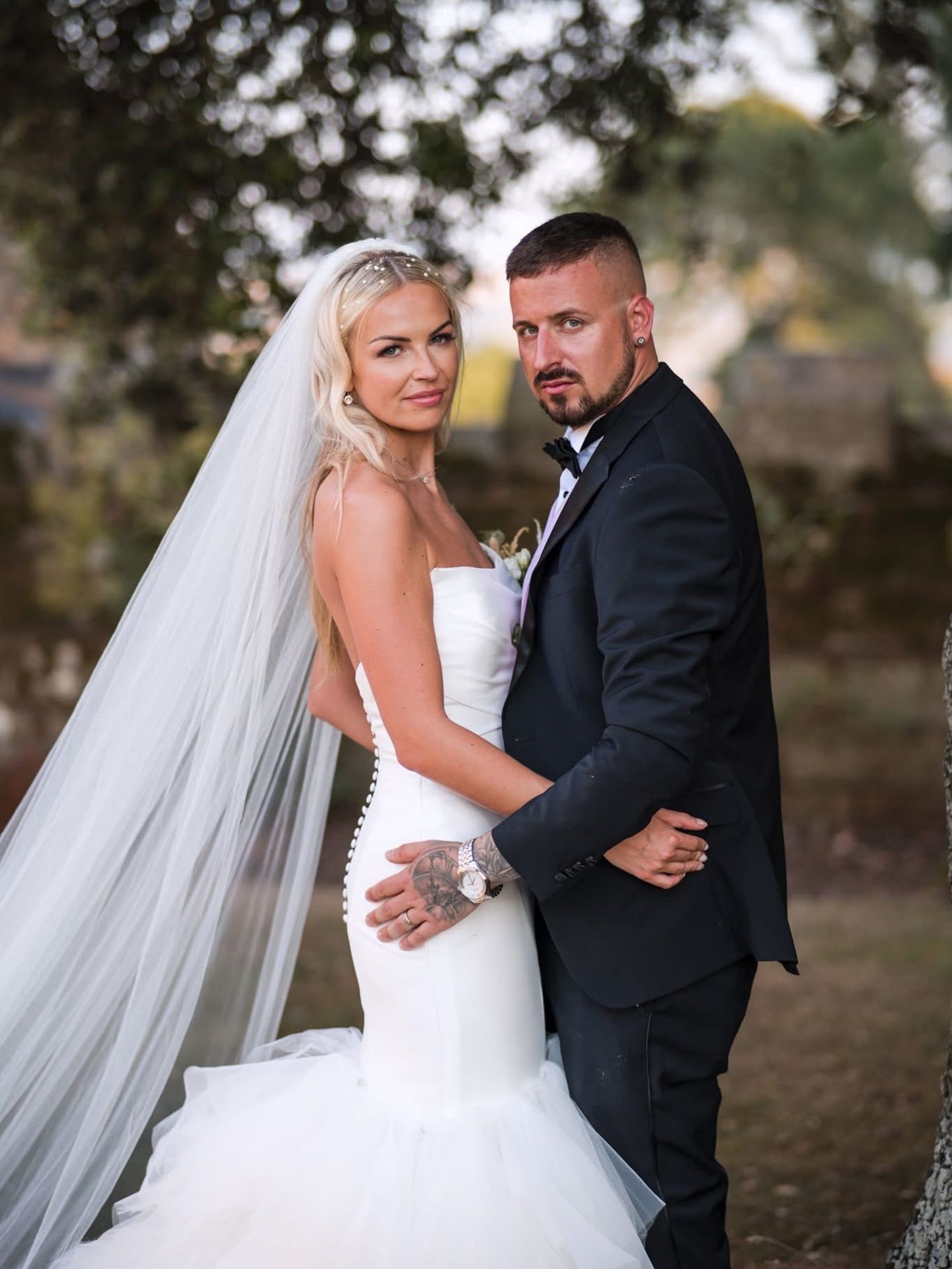 Romantic wedding portraits of couple in formal attire outdoors.