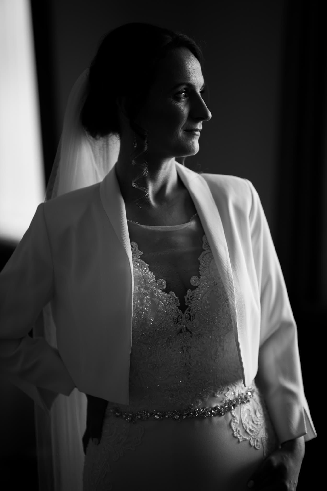 Black and white series of bridal gown details showing delicate lace and beadwork in dramatic lighting.