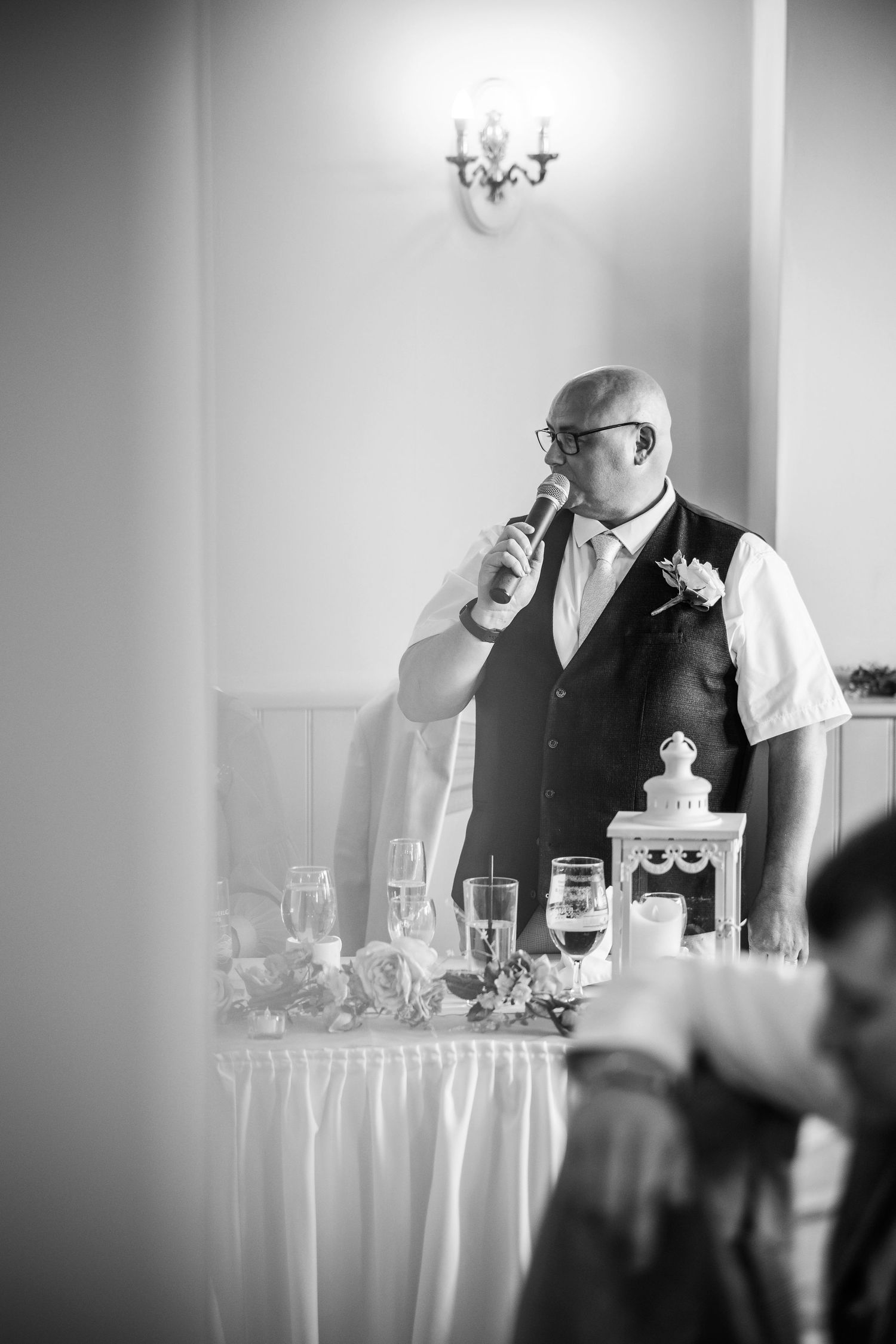 Black and white photo series of a bartender preparing drinks at an elegant wedding reception bar.