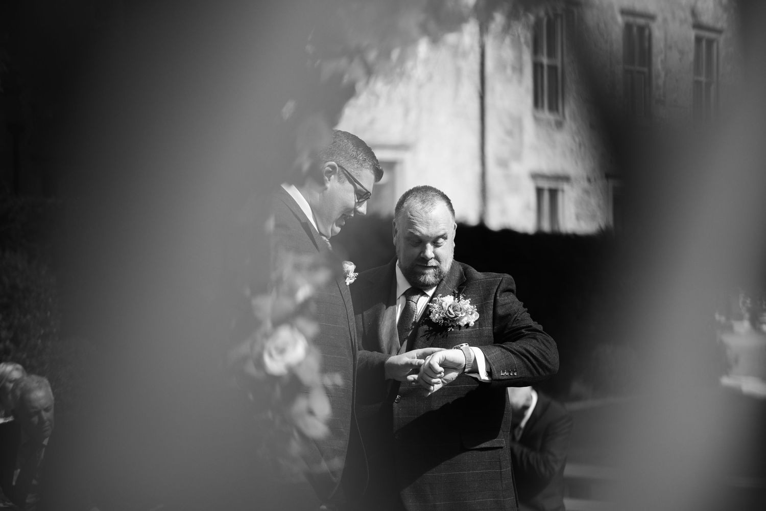 A series of black and white photographs showing a person smoking a cigar in various dramatic lighting conditions.