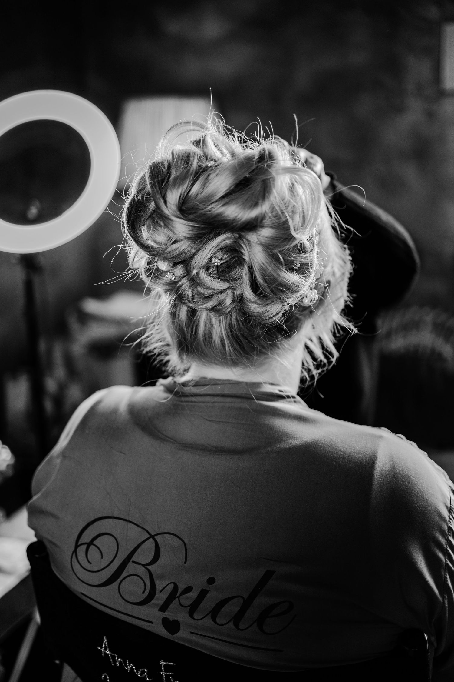 A black and white series of images showing the back of a bride's robe with elegant script lettering.