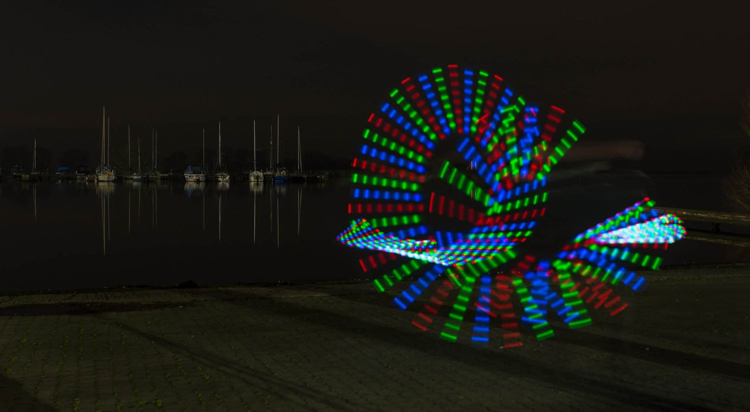 Light painting with blue and green lights on a night.