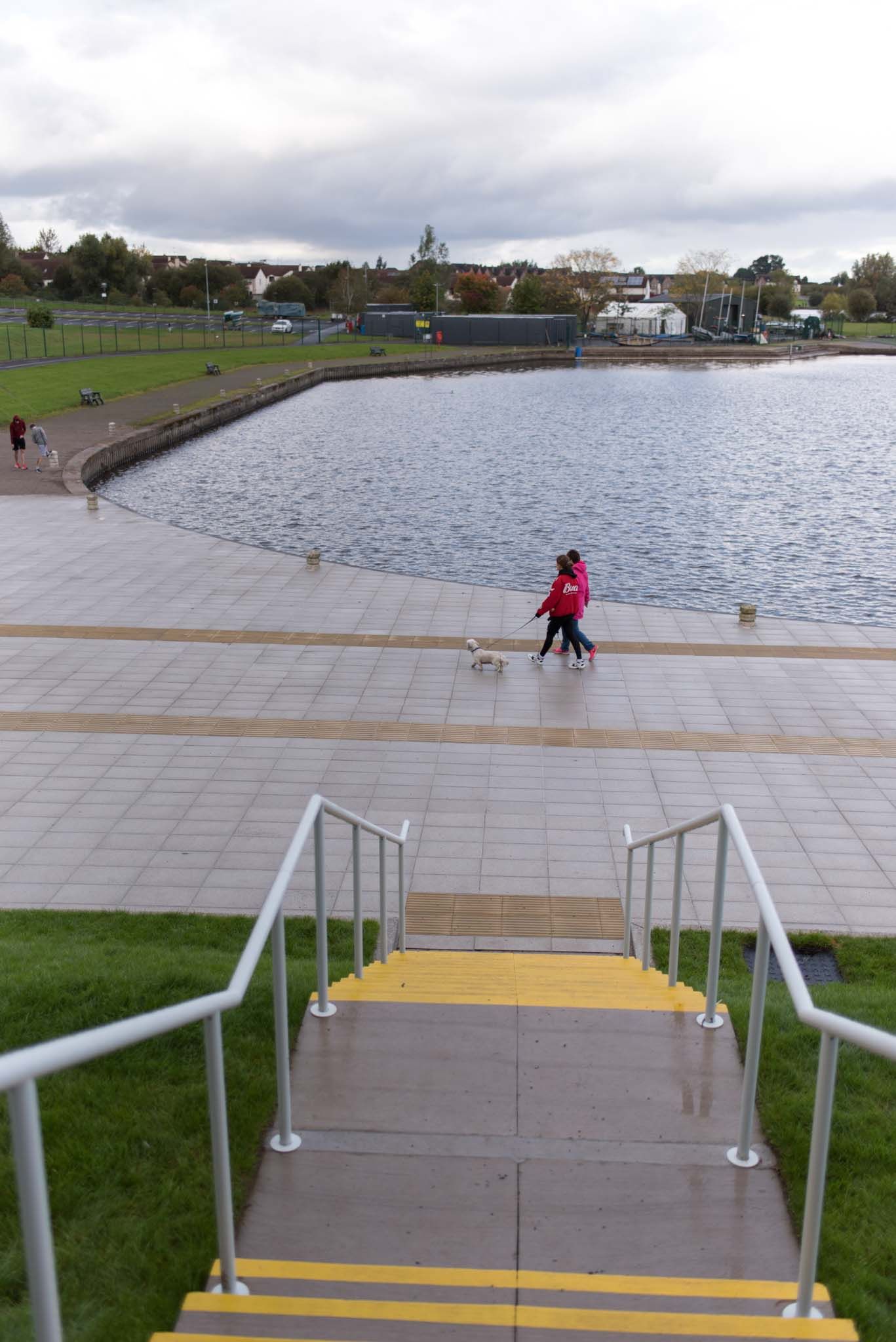 Looking down onto Craigavon Lakes as people walk.