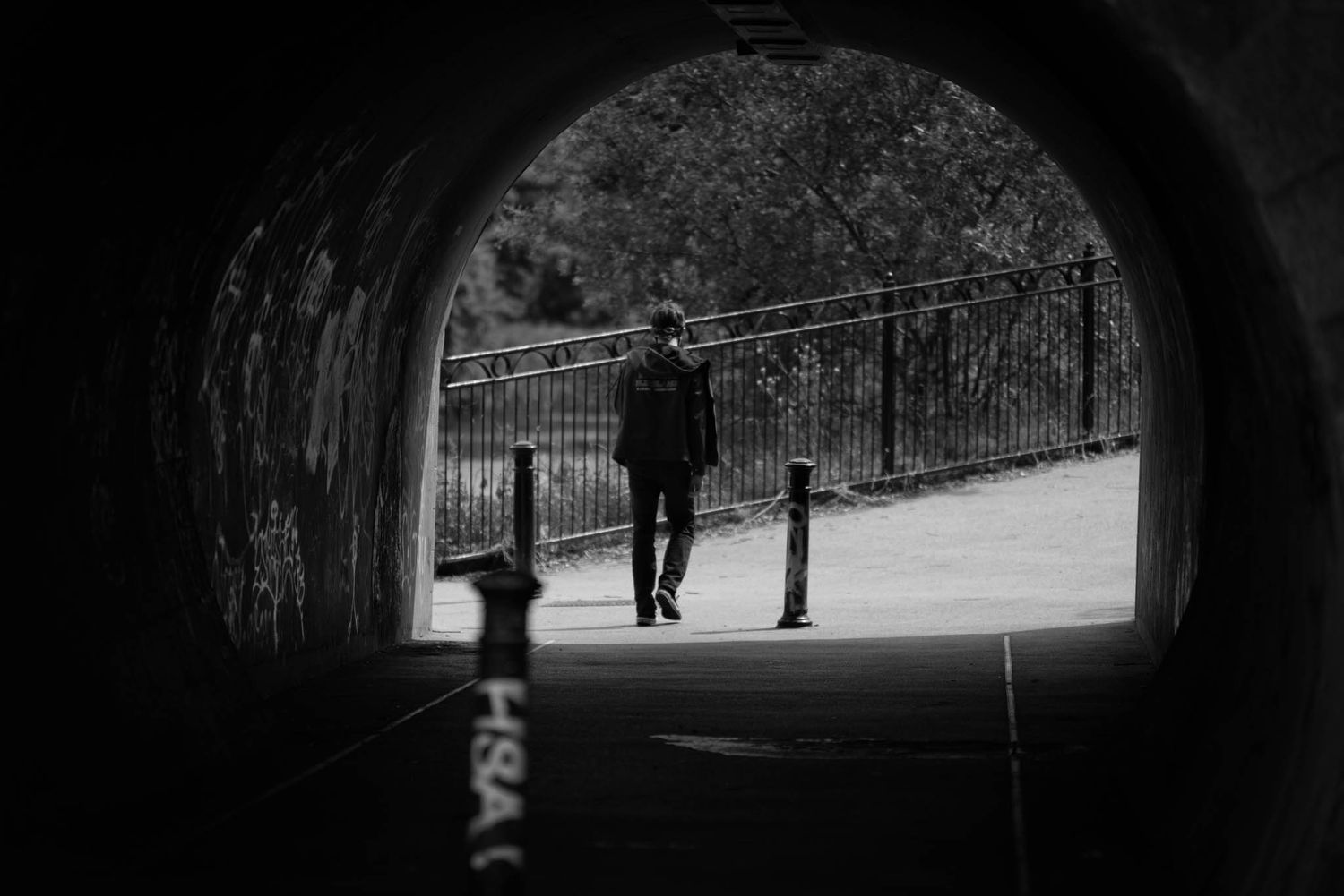 A person walking under the Bann Bridge is photographed in mono by Philip Exploring.