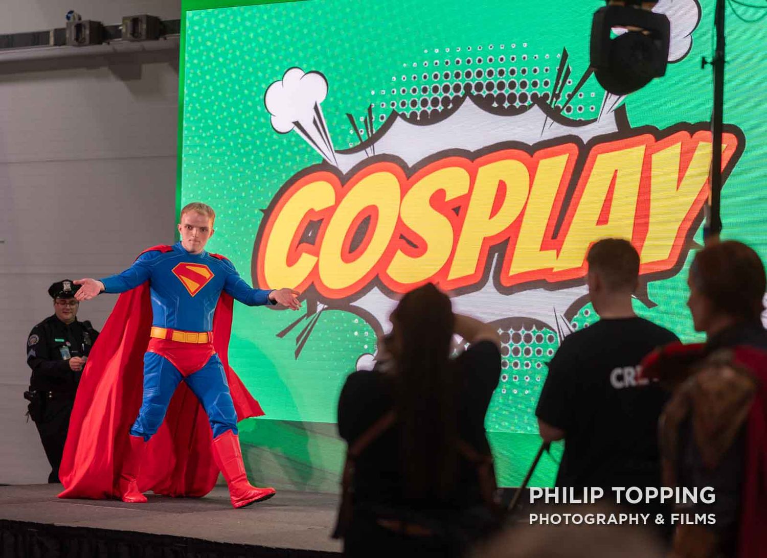 Superman cosplayer on stage.