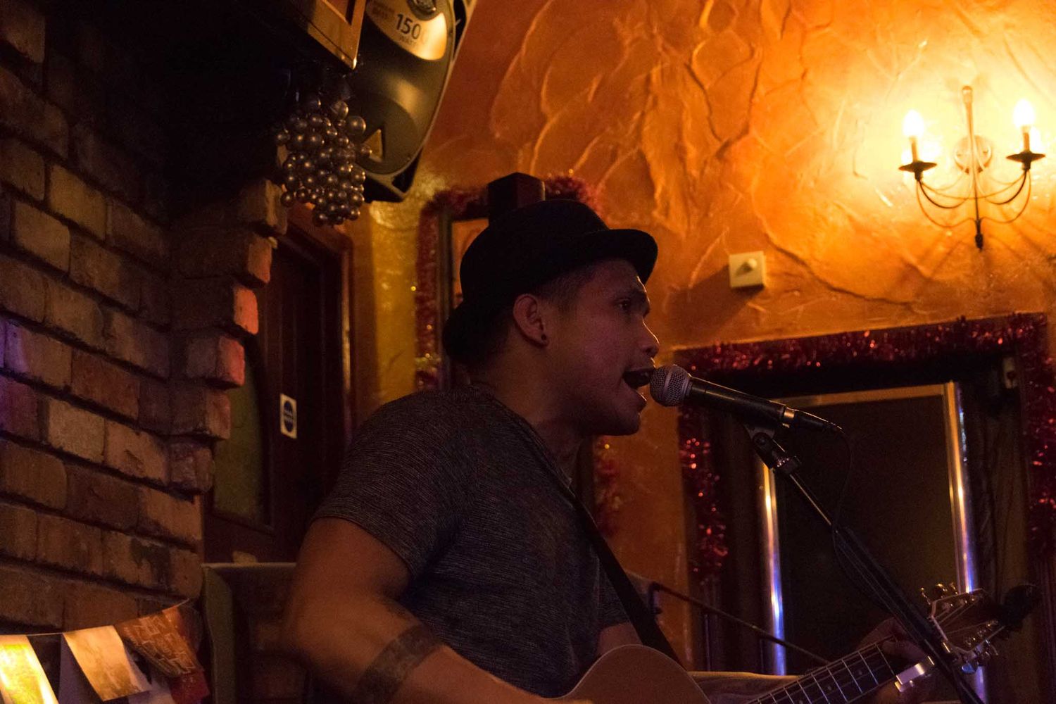 A guitarist singing in the bar.
