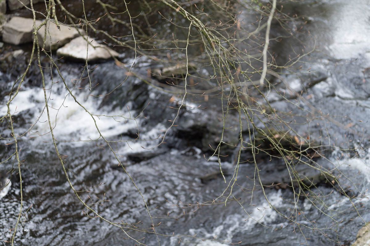 Water crashes against the wall in the river.