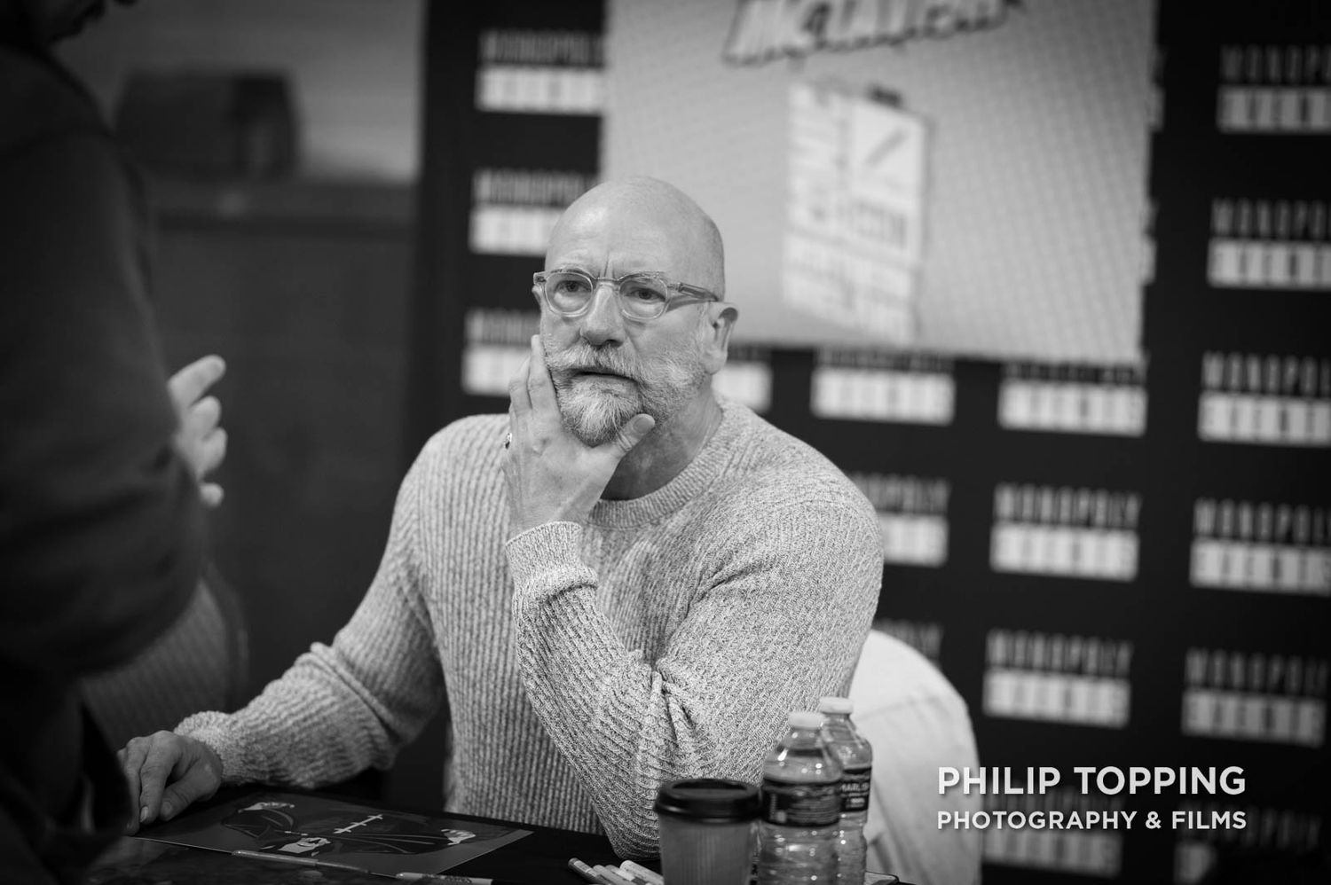 Mono image of actor Graham McTavish stroking his beard.