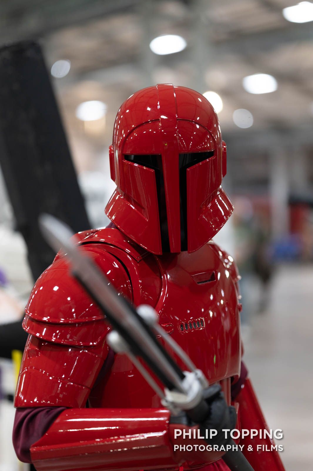 Red cosplyer with a spear from The Last Jedi.
