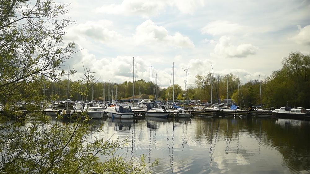 Boats lined up with water in the foreground.
