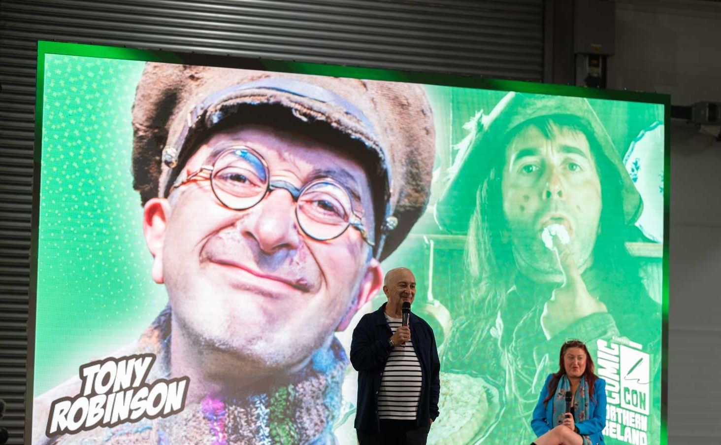 Tony Robinson at the Q&A in front of a large projected screen.