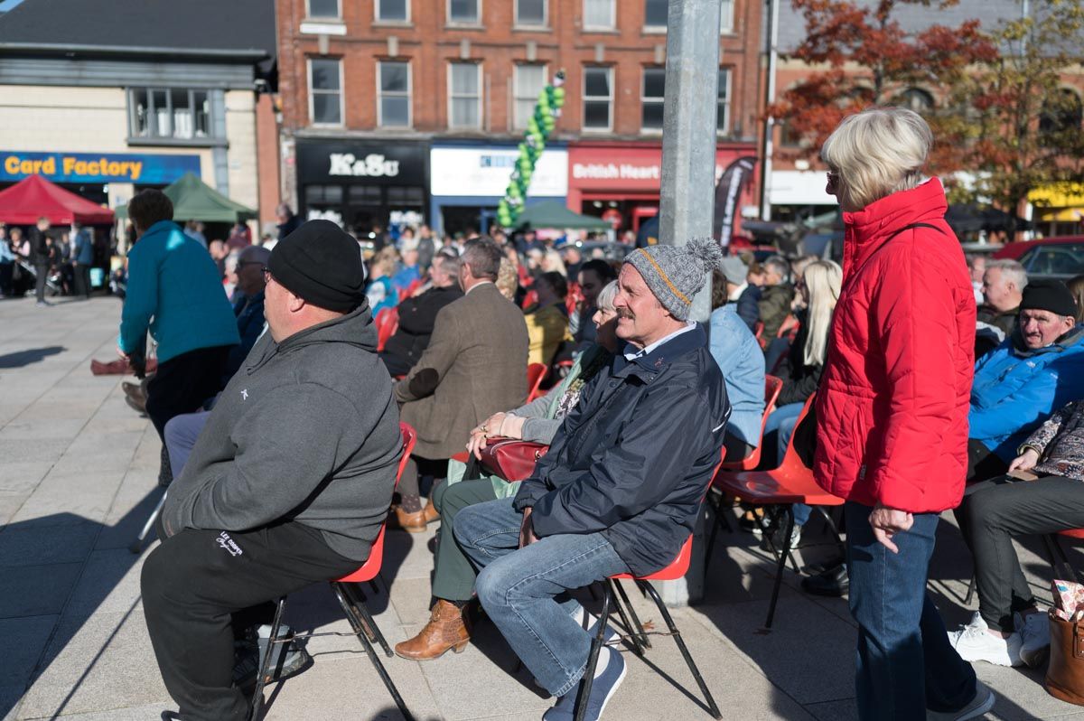 People are sitting watching the music play.