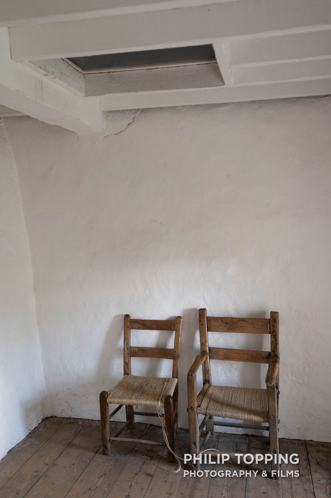 Two chairs with an entrance to the attic above.