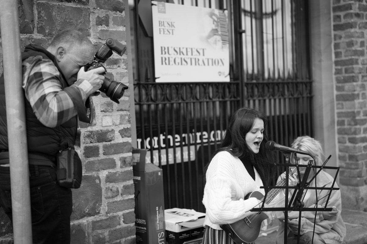 A photographer is photographing a close-up of a female singing.