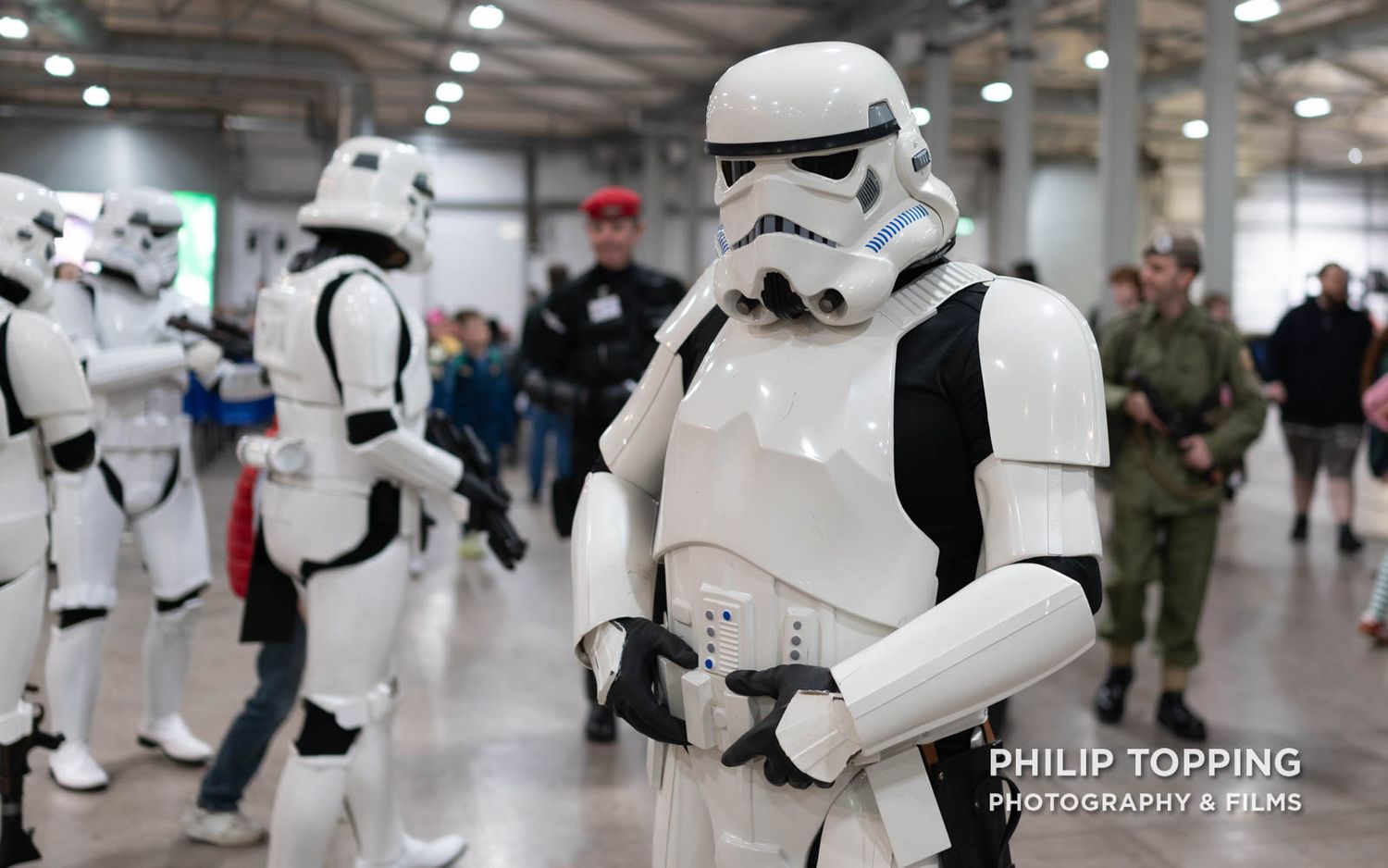 Stormtrooper has hands on the belt, looking at the camera.