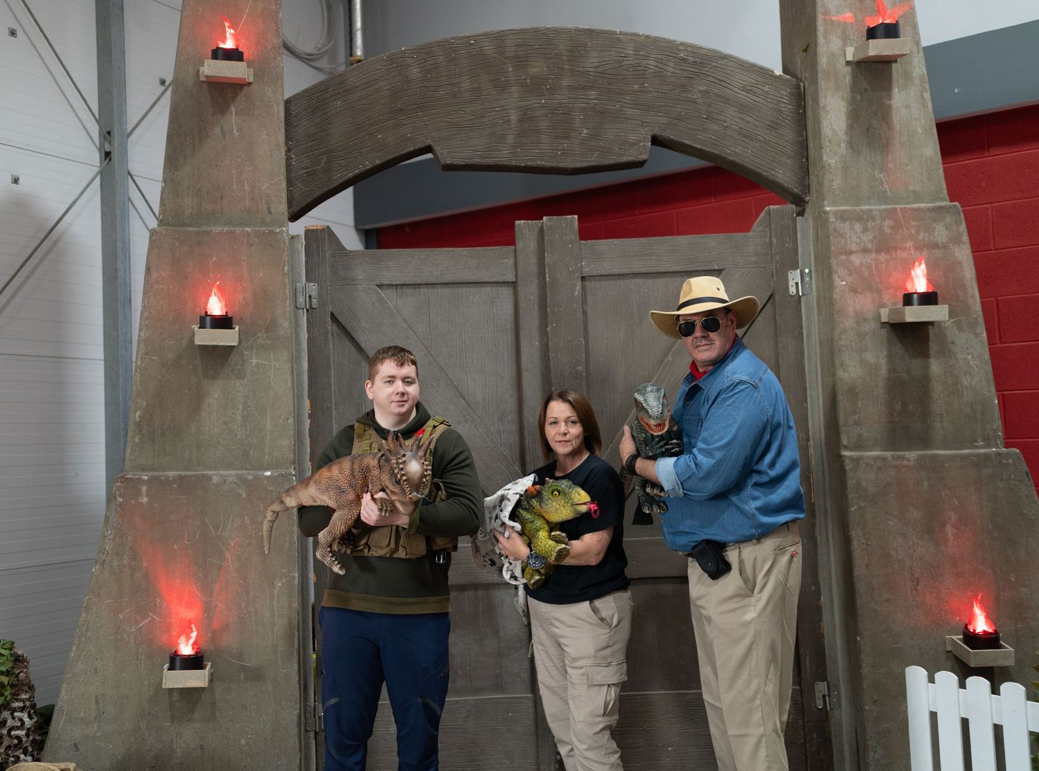 Cosplayers as Jurassic Park characters in front of a large prop.