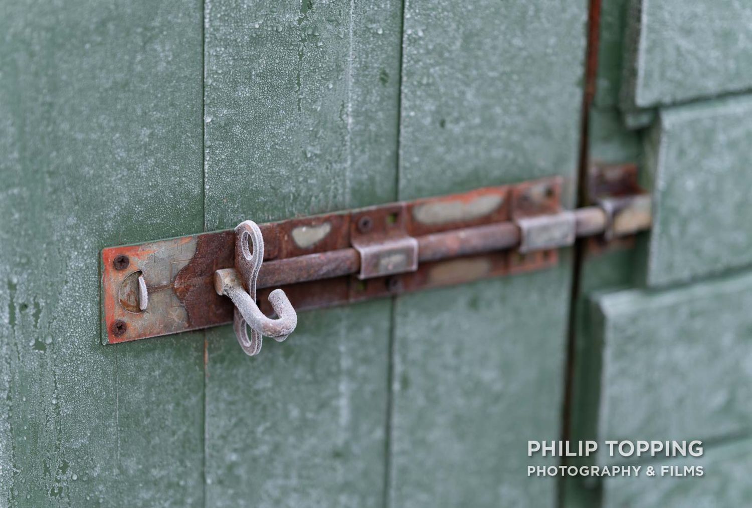 Close-up of a green shed bolt in cold conditions.