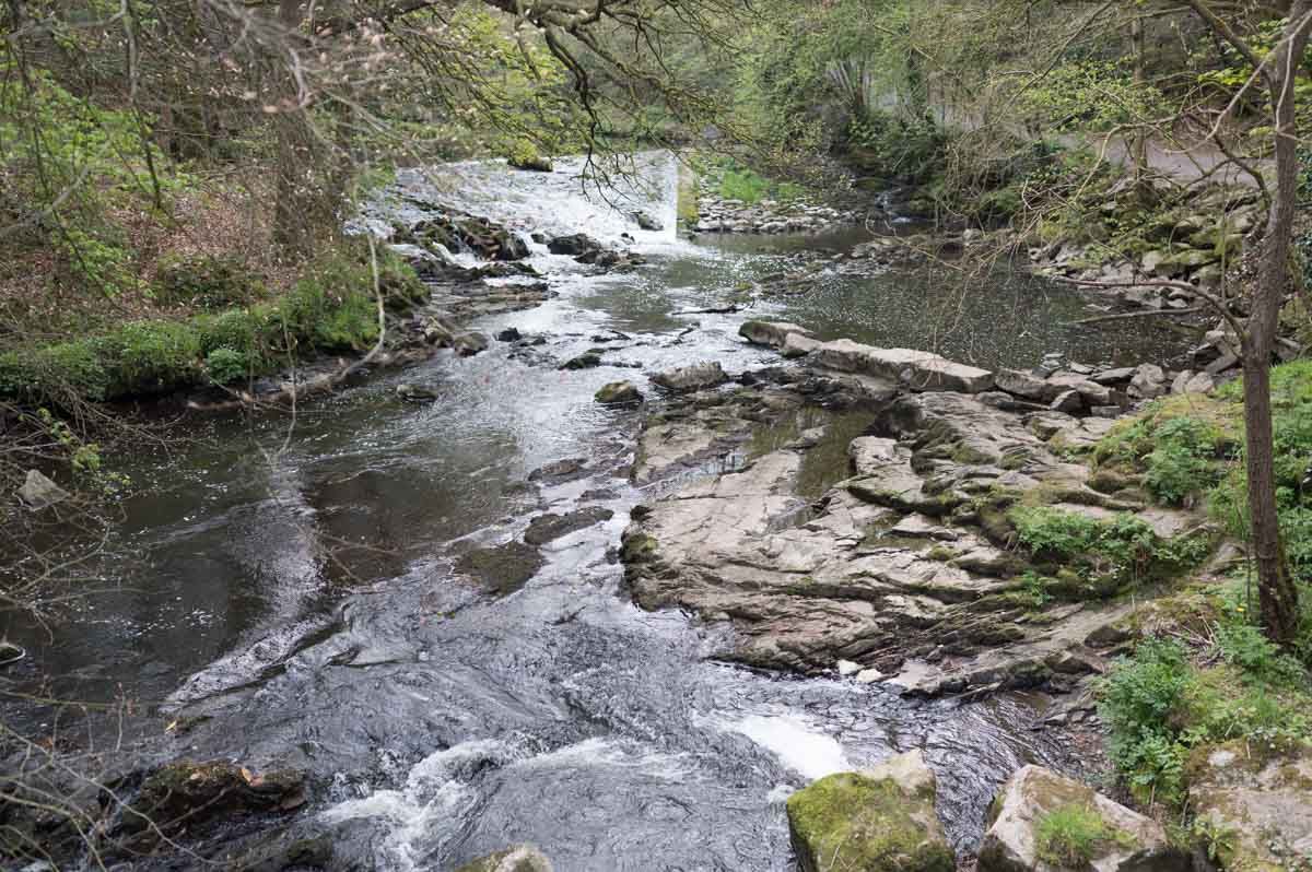 Wide photo of water running down a river.