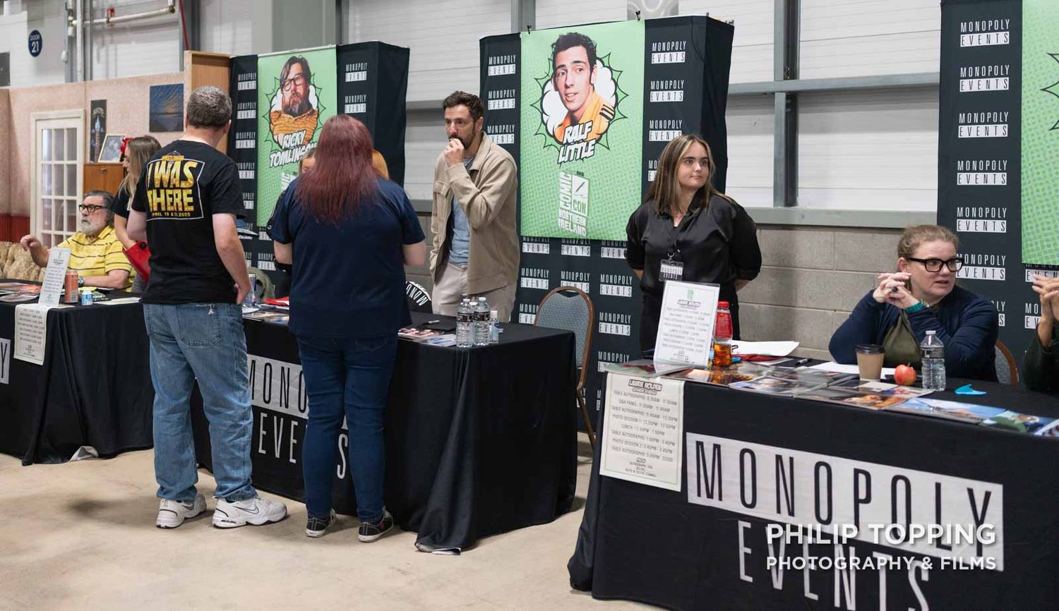 Wide photo of Ralf Little from The Royle Family BBC series, standing up at his table chatting.