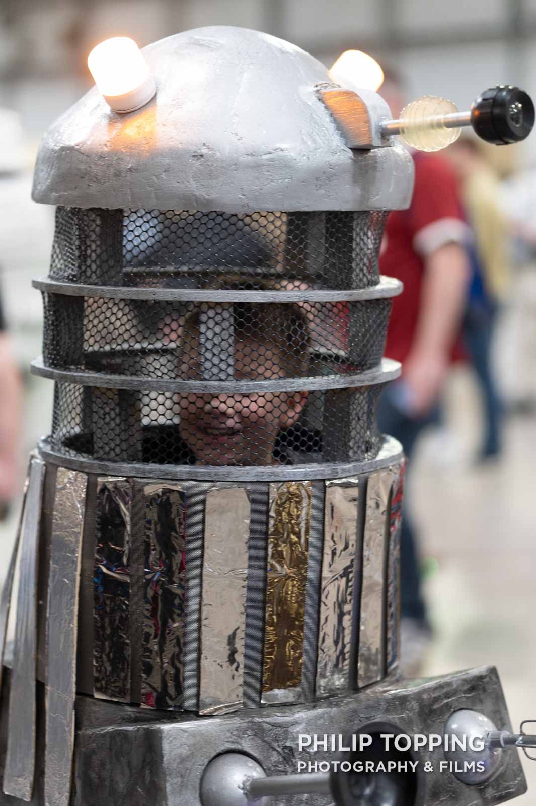 Close-up of a young kid in a DIY Dalek.