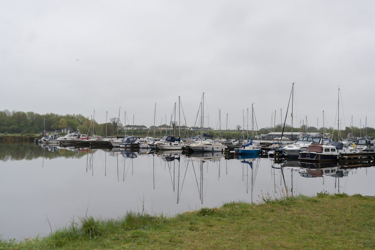 Boats and yachts lined up along the marina.