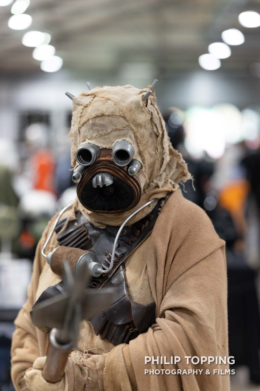 Cosplayer points a gun at the camera.