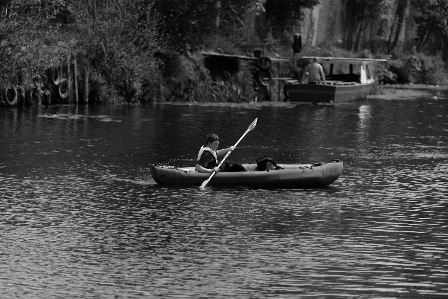 A canoeist paddling on the river.