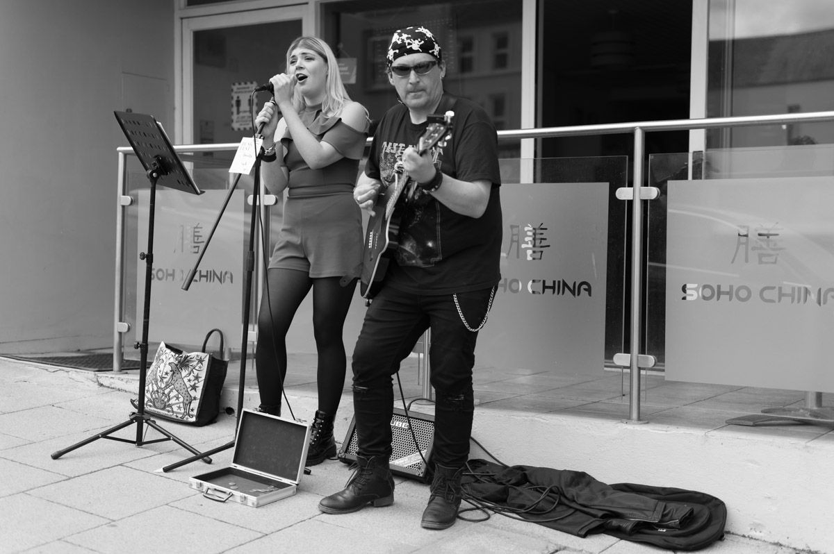 Male guitarists and female singing.