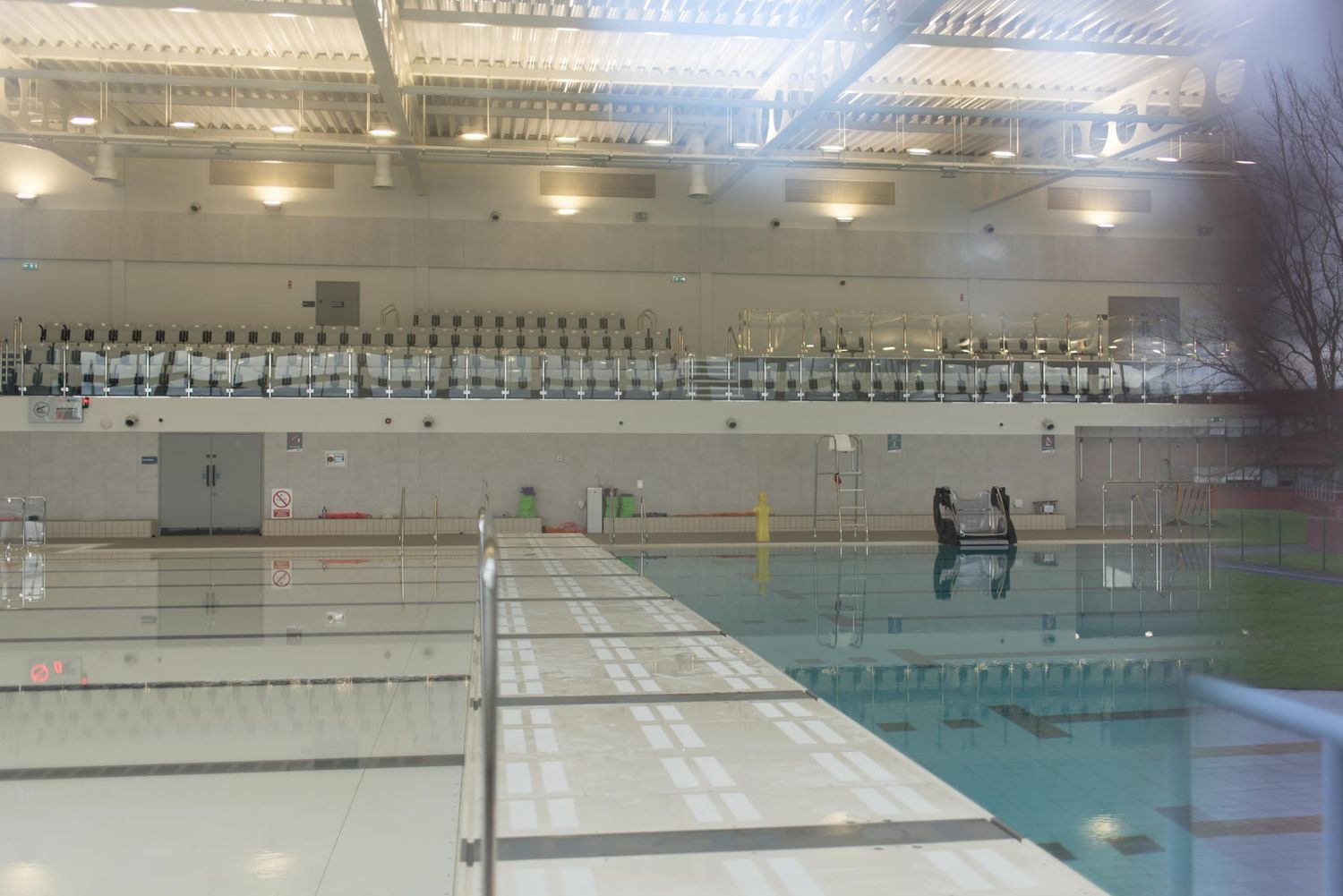 Swimming pool photographed through a window.