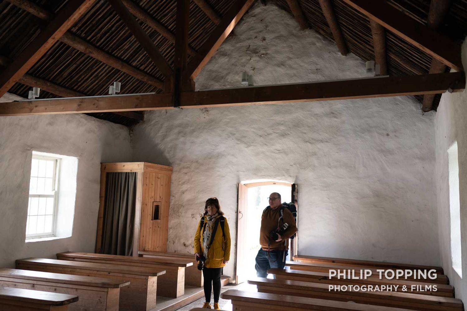 Photo club member John Lambe walks into the building with another member.