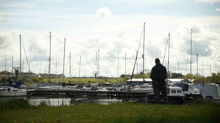 Main photographed in silhouette, looking at boats in Kinnego Marina.