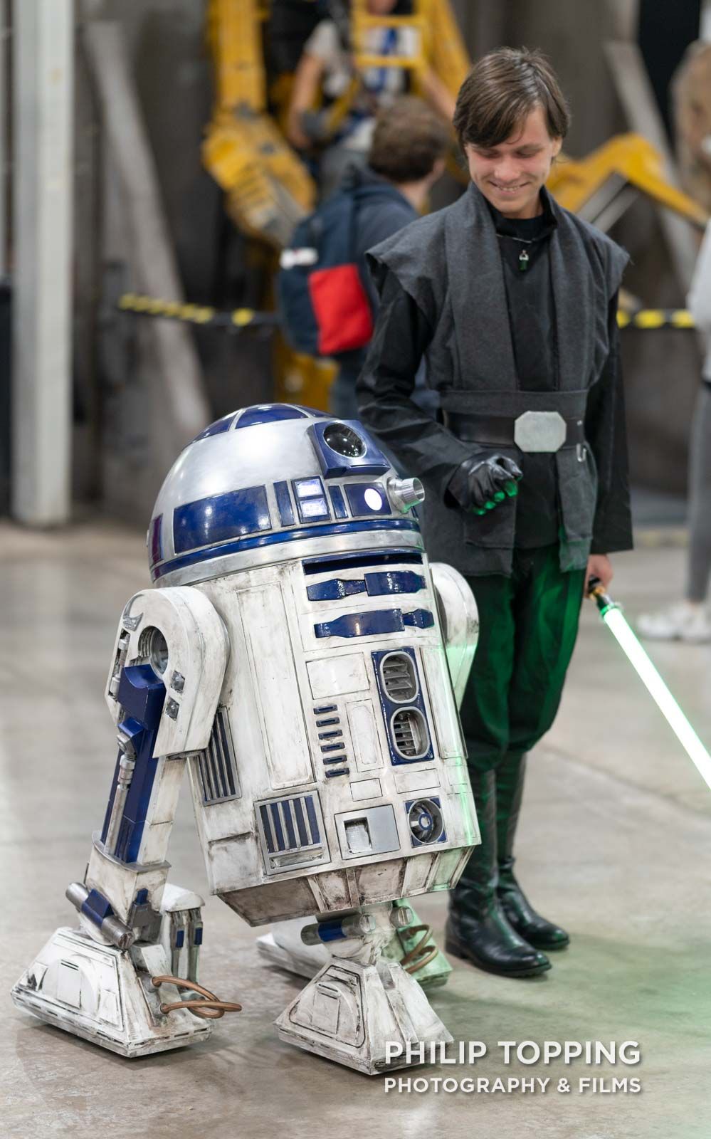 R2-D2 with Jedi dressed in black.