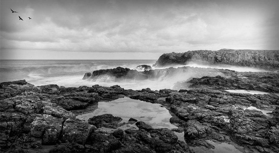 Mono image as the waves exploded against the rocks, as I photographed this image at the Photography Club.