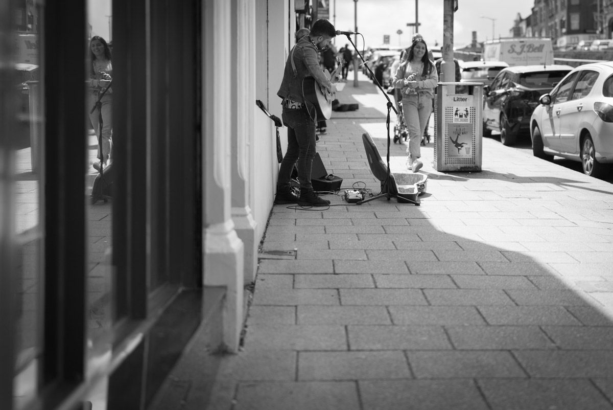 Busker outside of shop in Banbridge.