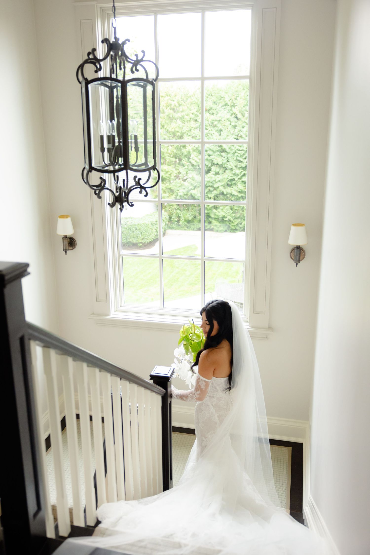 Four elegant bridal photos showcase a flowing white wedding veil and dress against a bright interior window setting.