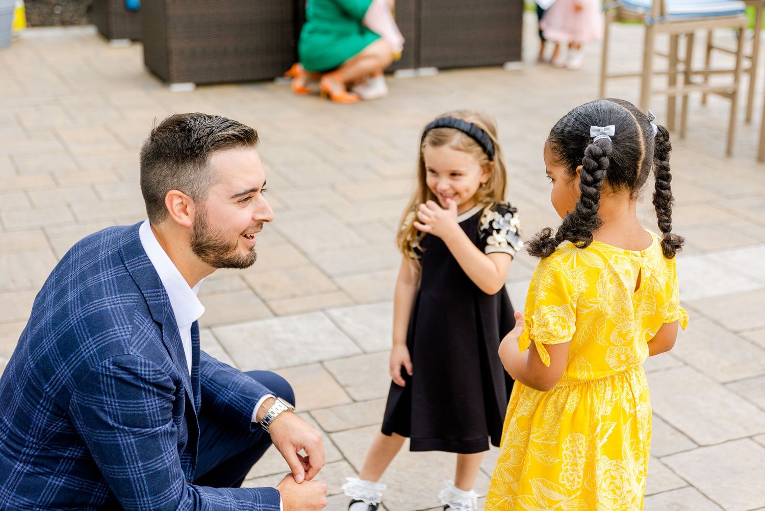 Candid moment between guests during an outdoor gathering.