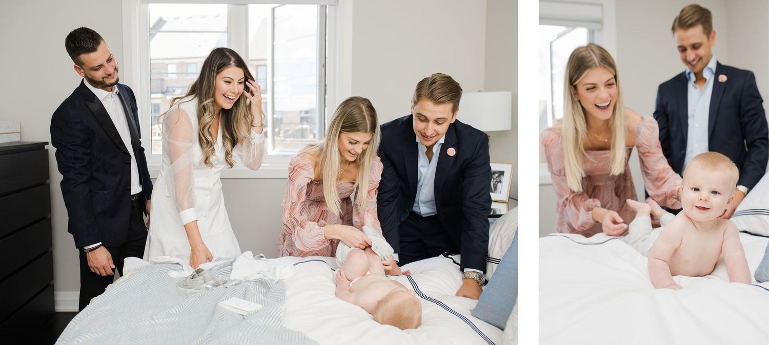 Family gathered around white bed for baptism ceremony.