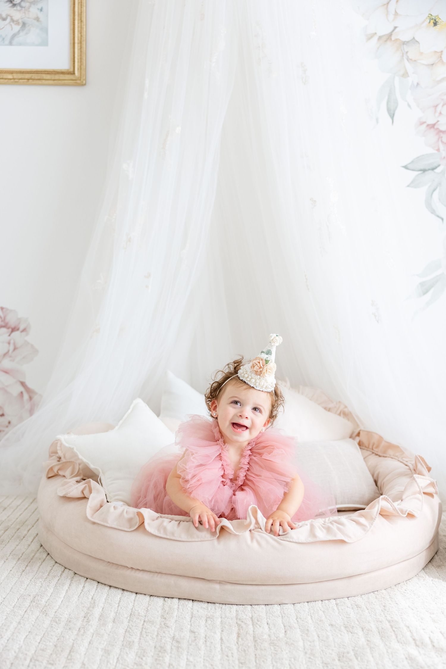 Festive celebration scene with pink tulle dress and party hat in a light-filled room.