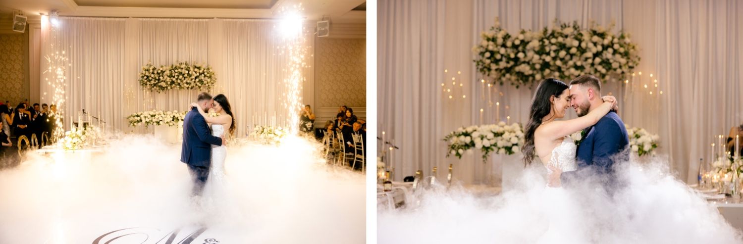 Romantic first dance with fog machine effects creating a dreamy atmosphere at an elegant wedding reception.