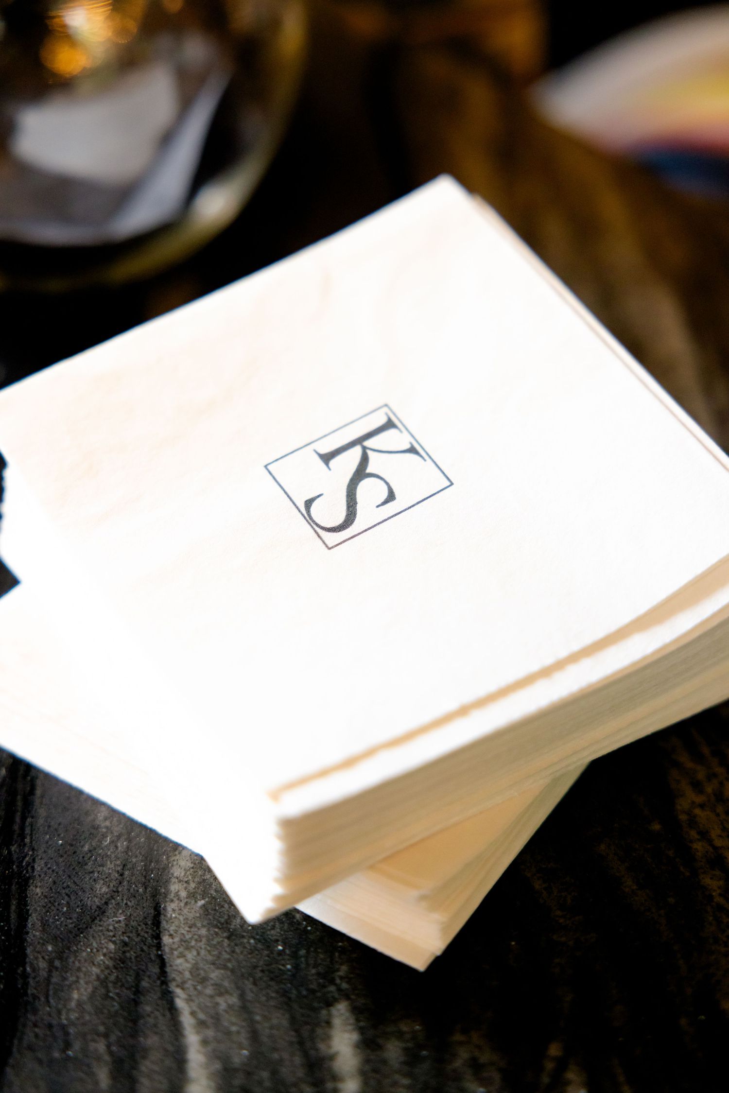 Stack of white napkins with monogrammed KS logo.