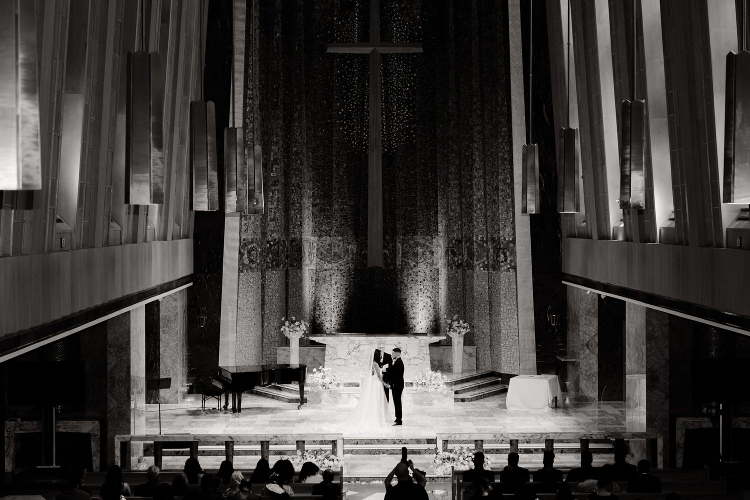Dramatic black and white photo of church altar with dramatic lighting.