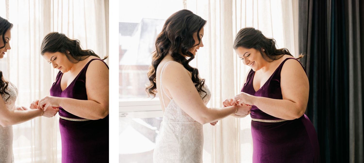 Intimate getting ready moments between bride and wedding party member by window.