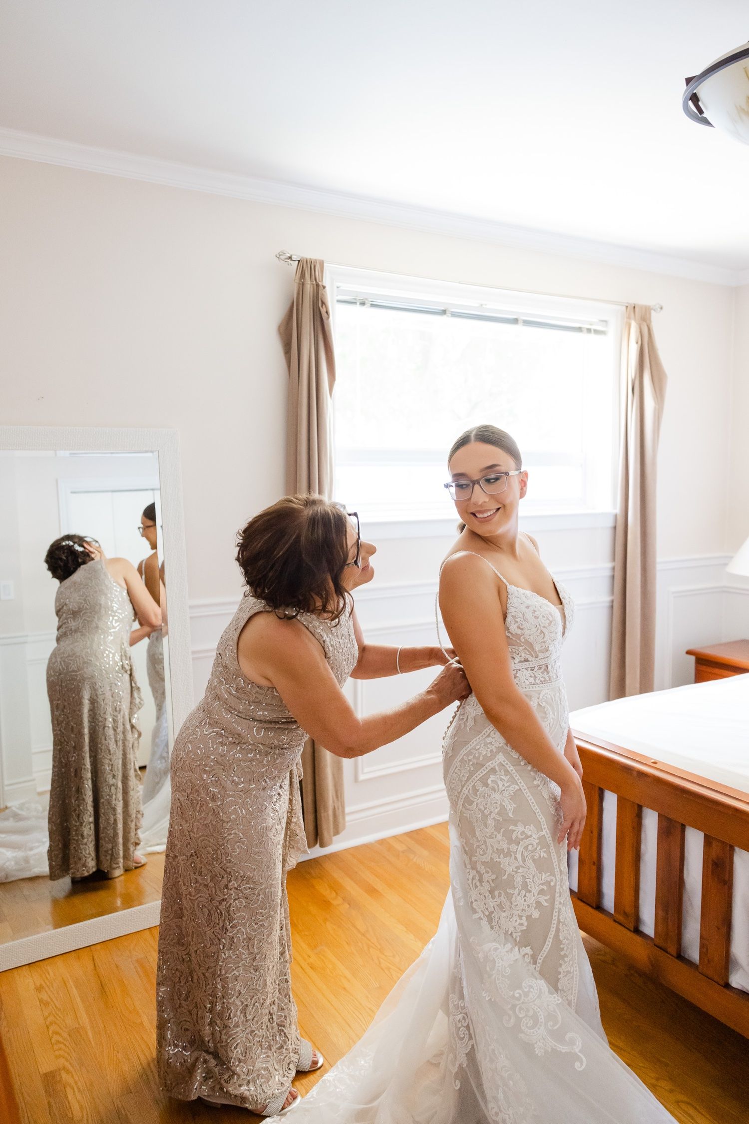 A heartwarming moment during wedding preparations with two people in formal attire.