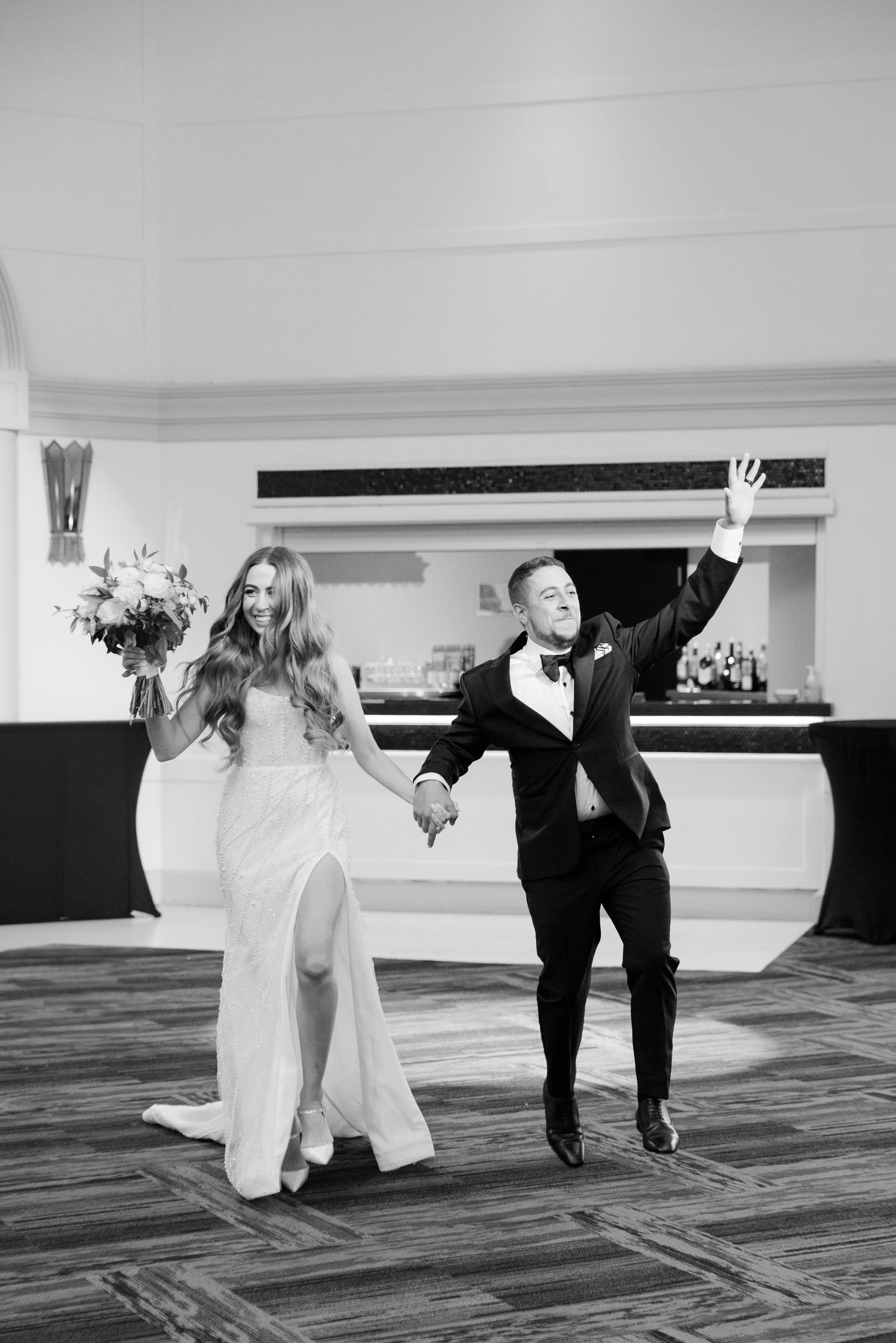 A celebratory moment during a wedding reception featuring elegant decor and joyful movement.