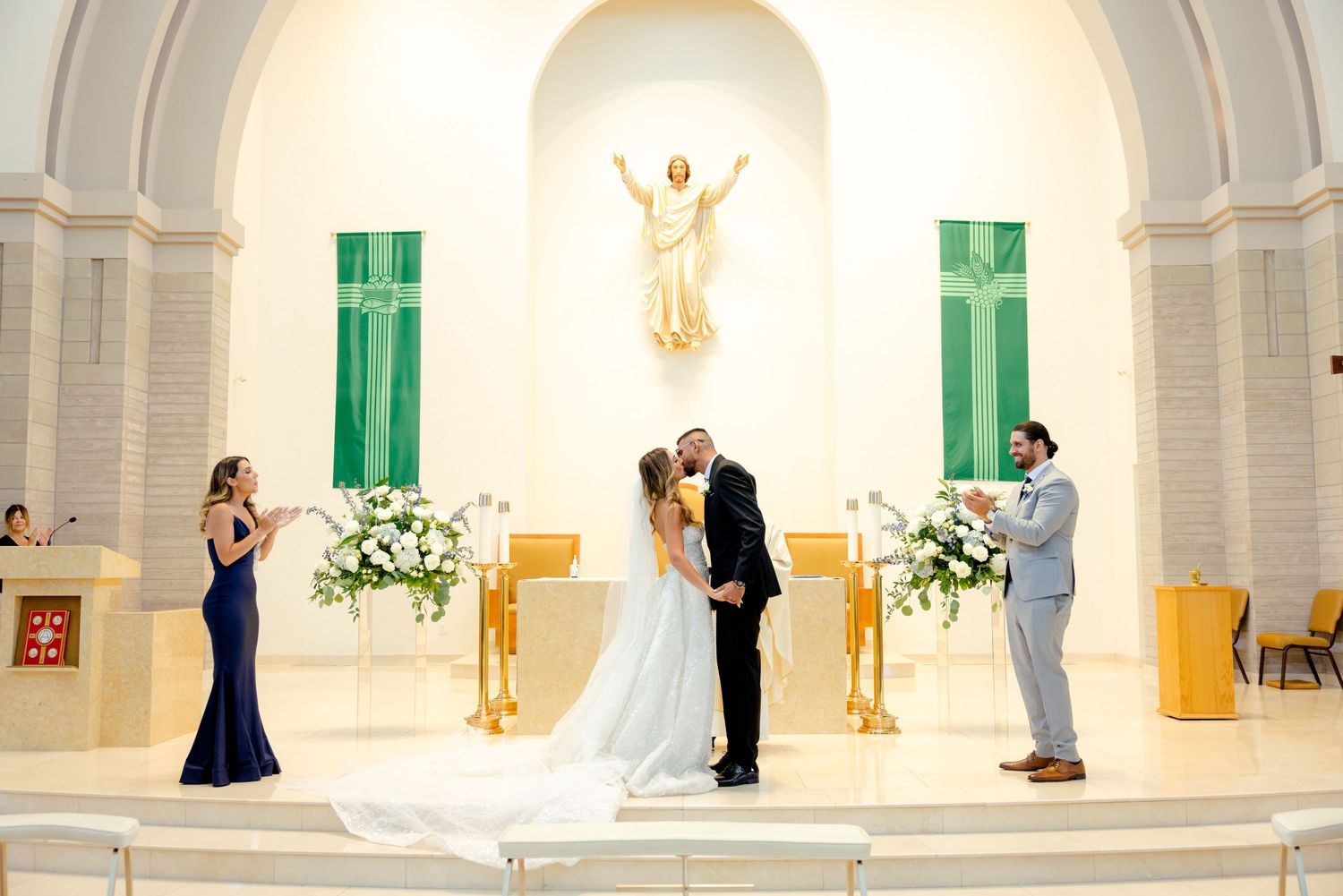 Religious wedding ceremony with beautiful altar decorations and dramatic lighting in a modern church setting.